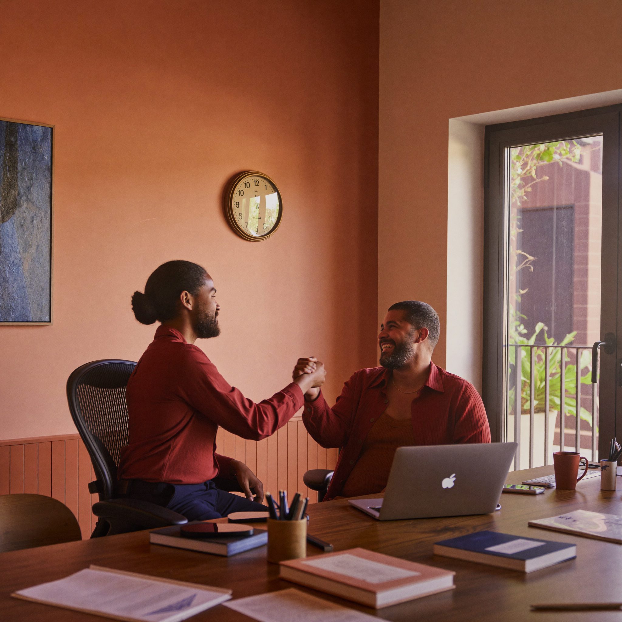 Client and bookkeeper shaking hands after a consultation
